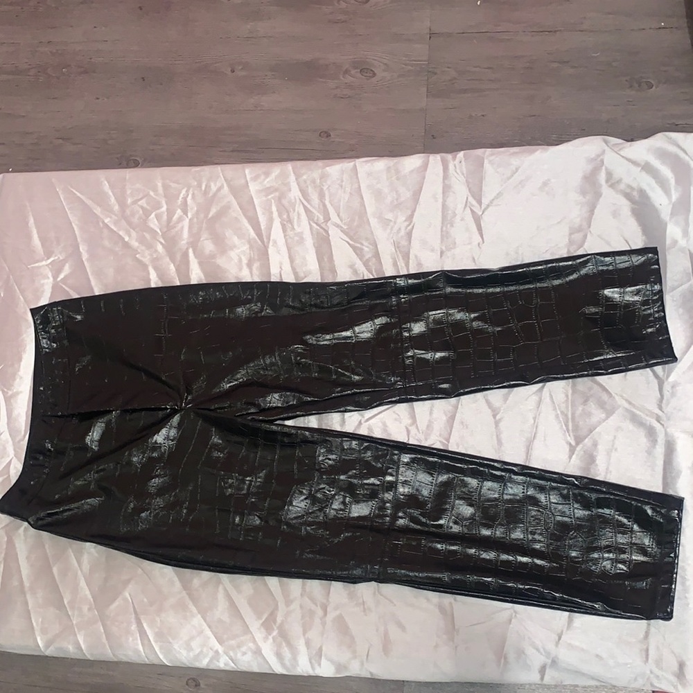 Black crocodile print leather pants.